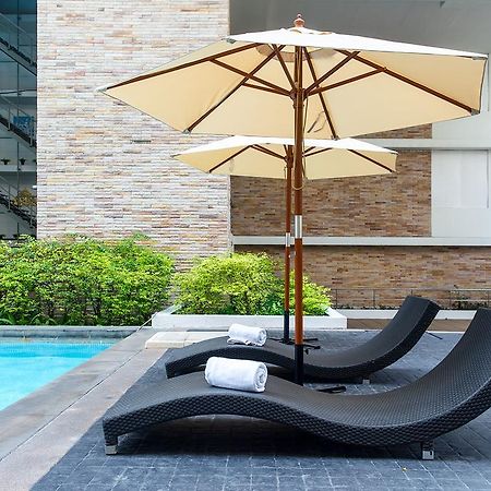 The Capital Resort @ Sukhumvit 50 Bangkok Exterior photo Sunloungers by a pool