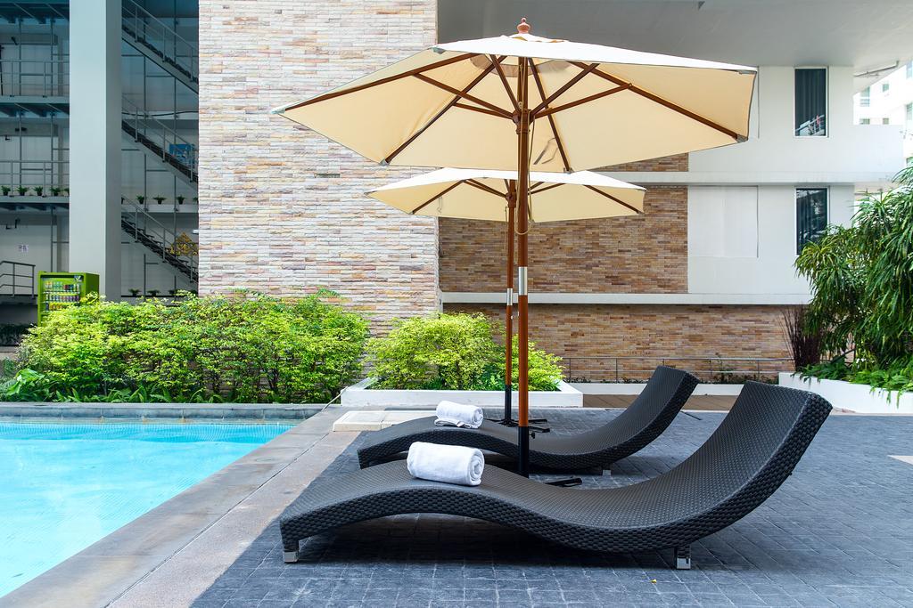 The Capital Resort @ Sukhumvit 50 Bangkok Exterior photo Sunloungers by a pool